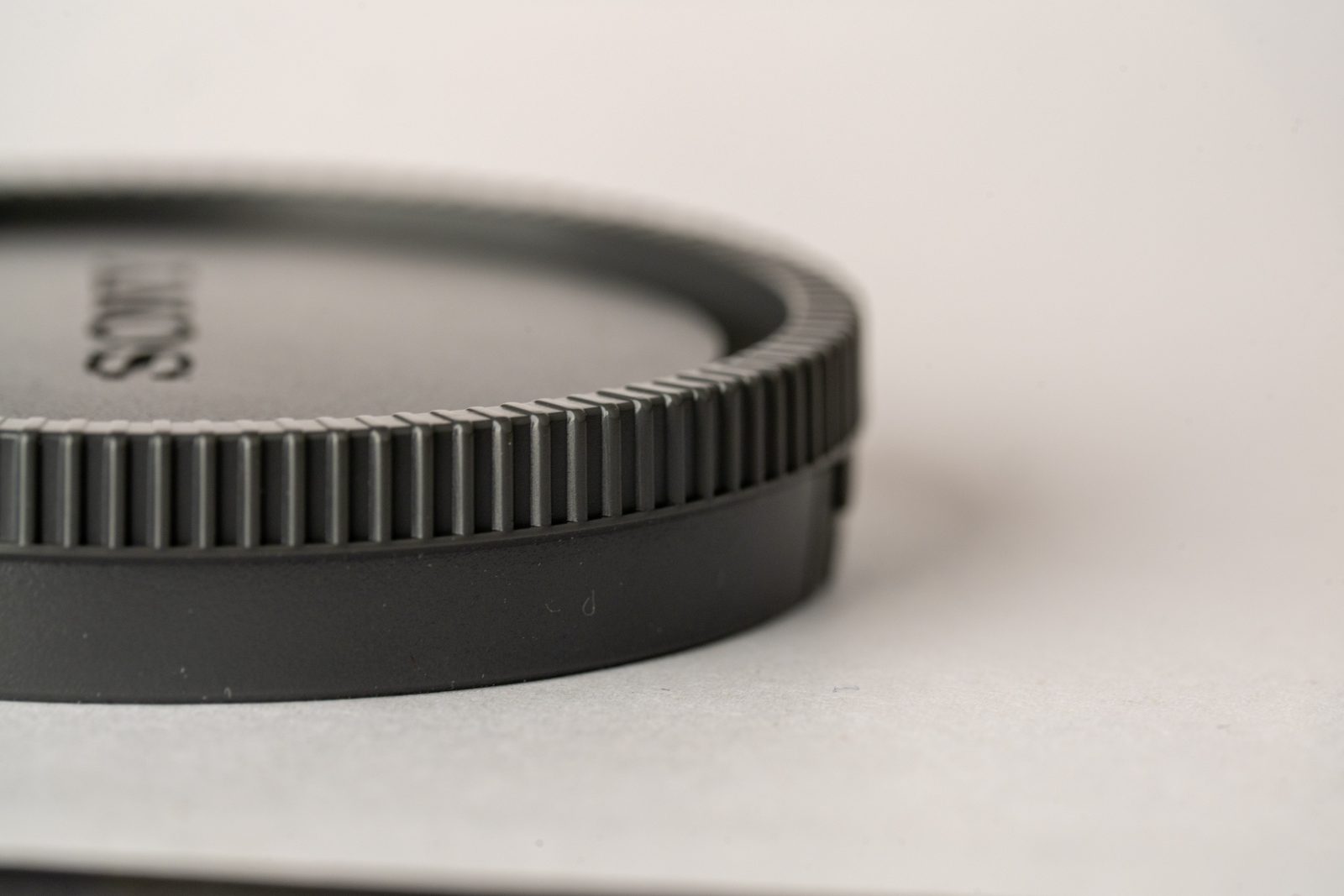 Sony Lens Cover — closeup photograph of camera gear, camera lens, close-up